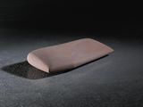 a soap bar sitting on a black surface in the dark