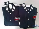 two baseball jackets with logos on them sitting next to each other