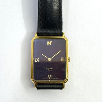 NINA RICCI Paris. Montre mixte, boitier rectangulaire en métal doré, c