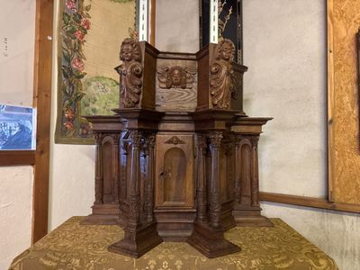 a small wooden table with a mirror on top of it