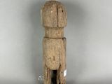 a small wooden figure that is standing on a table