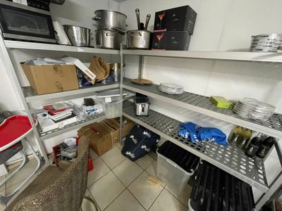 shelves with pots and pans on them in a kitchen