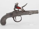 un pistolet en argent sur lequel est perché un homme