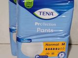 two packs of tena protection pants sitting on top of each other