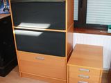 a desk with a computer on top of it in a room