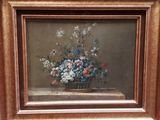 tableau représentant un panier de fleurs posé sur une table, dans un cadre en bois
