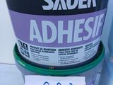 a bucket of adhesive next to a can of paint