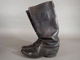 pair of black leather boots on a white surface