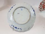 a blue and white plate sitting on a white table