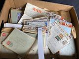 a cardboard box filled with many different types of mail