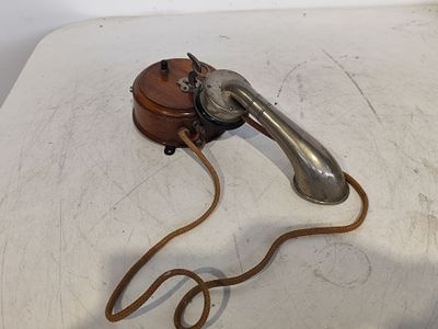 a telephone on a table with a cord attached to it