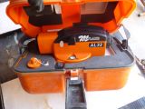 an orange case with a black handle on top of it