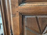 a close up of a wooden door with a metal handle