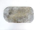 a stone with a hole in it sitting on a white surface