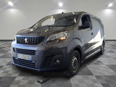the small van is parked in a large room with a checkered floor