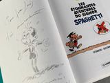 an open book with a drawing of a cartoon character on it