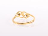 a close up of a gold ring on a white surface