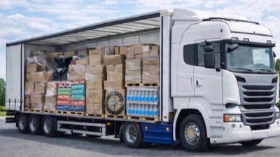 a semi truck with a large load of boxes on the back of it