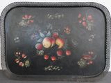a black tray with fruit on it sitting on a table