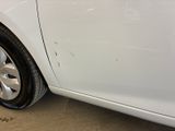 a close up of a car ' s tire on the side of the road