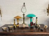 a table with a lamp, a lamp shade, and other items on it