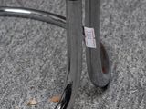 a close up of a black and silver umbrella on the ground