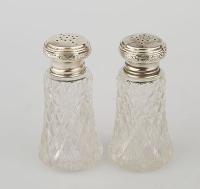 a pair of cut glass salt and pepper shakers