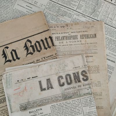 several old newspapers are stacked on top of each other