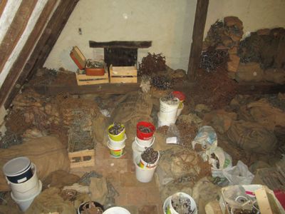 many buckets and containers of food sitting on the floor