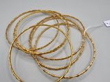a set of five gold plated bracelets with twisted wire