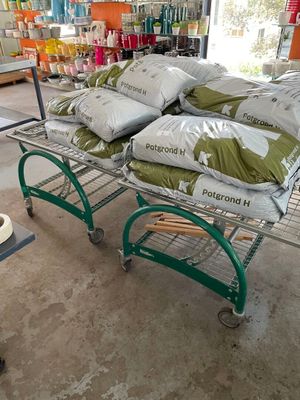 many bags of food on a cart in a store