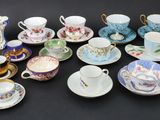 many cups and saucers that are sitting on a table