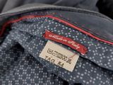 the back of a blue jacket with a red and white polka dot pattern
