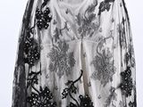 an image of a dress with black lace and flowers on a mannequin mannequin