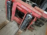 a forklift that is sitting in the middle of the floor