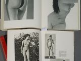 an open book with black and white photos of a naked woman