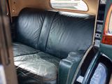 a black leather couch sitting in the back of a car