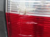 the tail light of a car with a bullet hole in it