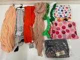 many different types of scarves and scarves hanging on a wall
