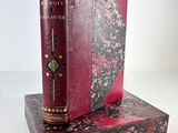 an old book is sitting on top of a book stand