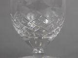 a close up of a glass on a table with a gray background