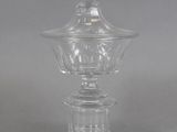 an antique clear glass bowl with a domed lid
