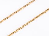 a close up of a gold chain on a white background