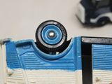 a close up of a toy truck with a toy car in the background