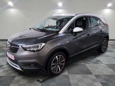 the grey opel is parked in a room with a checkered floor