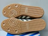 the soles of a pair of adidas shoes on top of a blue and white book