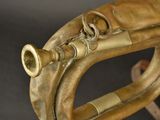 a brass instrument that is sitting on a stand
