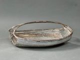 an image of a basket with a handle on a gray surface