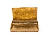 a gold box that is sitting on a white surface
