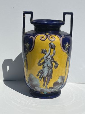 a blue and yellow vase with a painting on it
